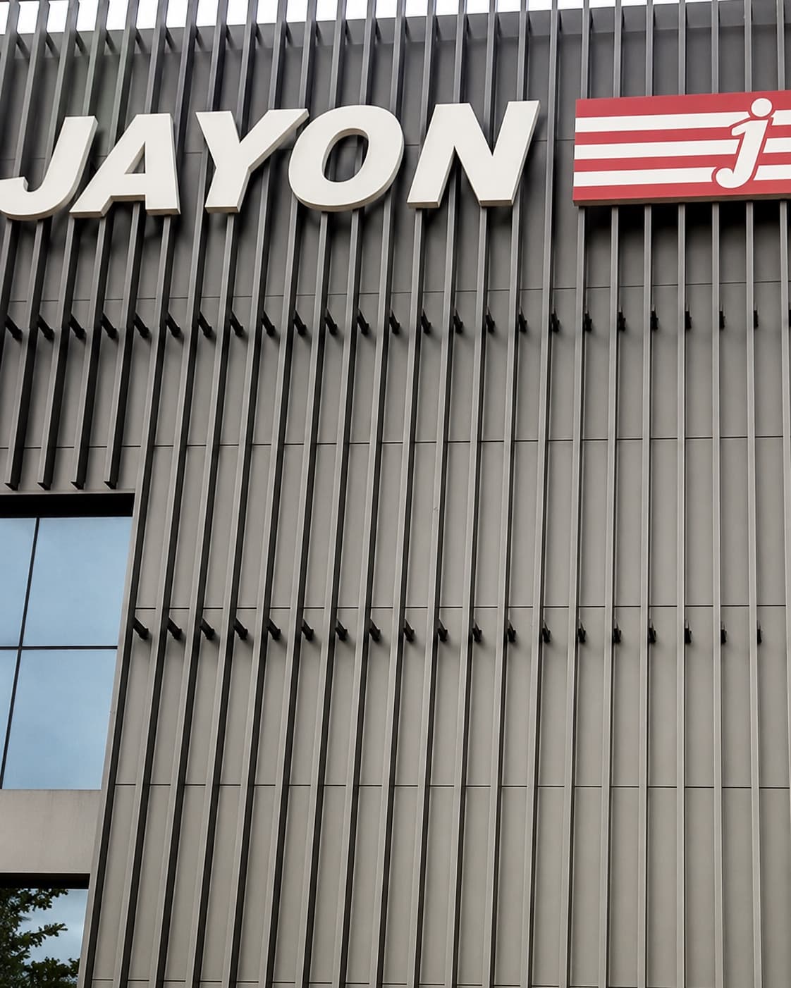 Jayon Factory — lettered signage on the dark fluted-metal facade