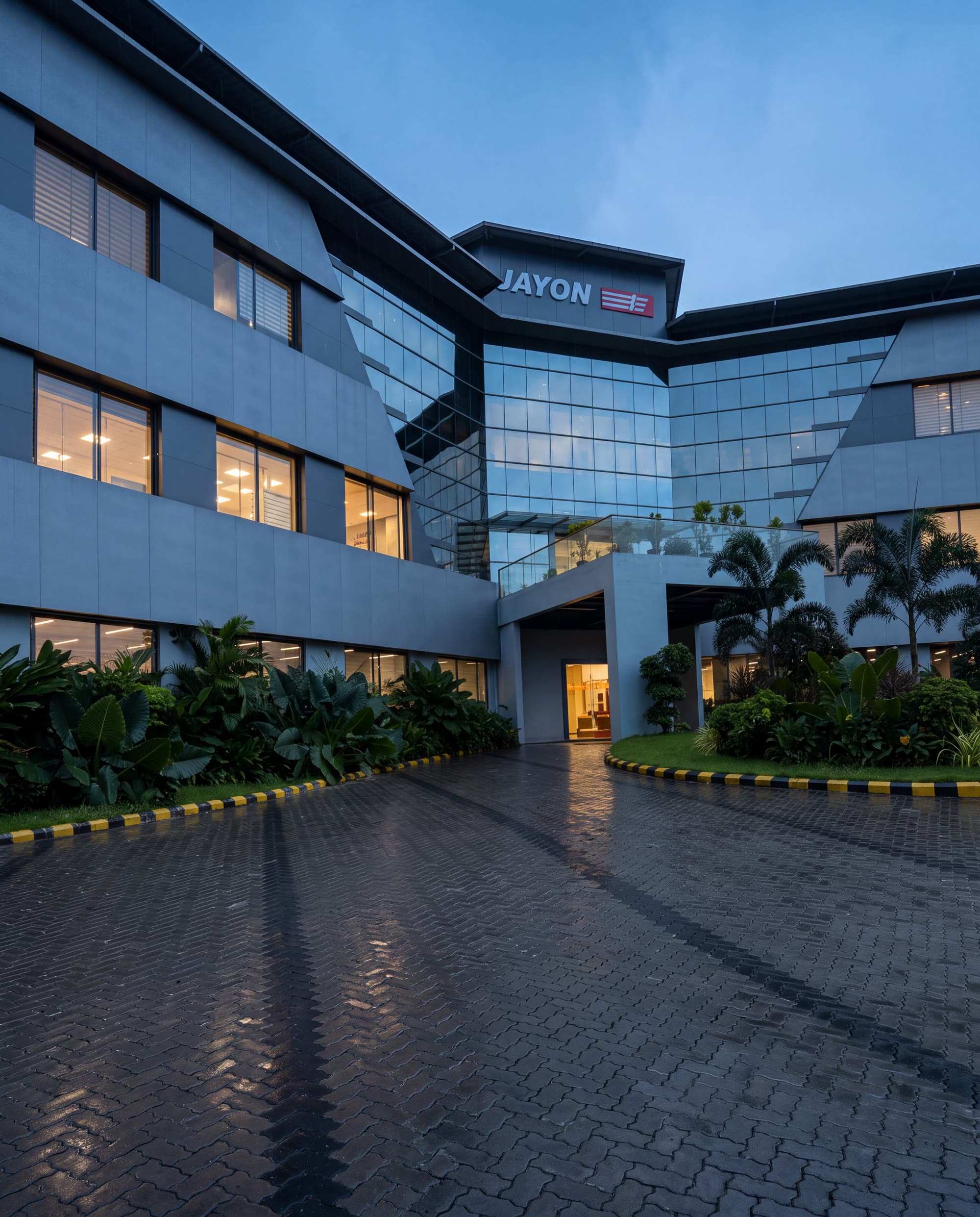 JMD — the entrance canopy and lit atrium at dusk