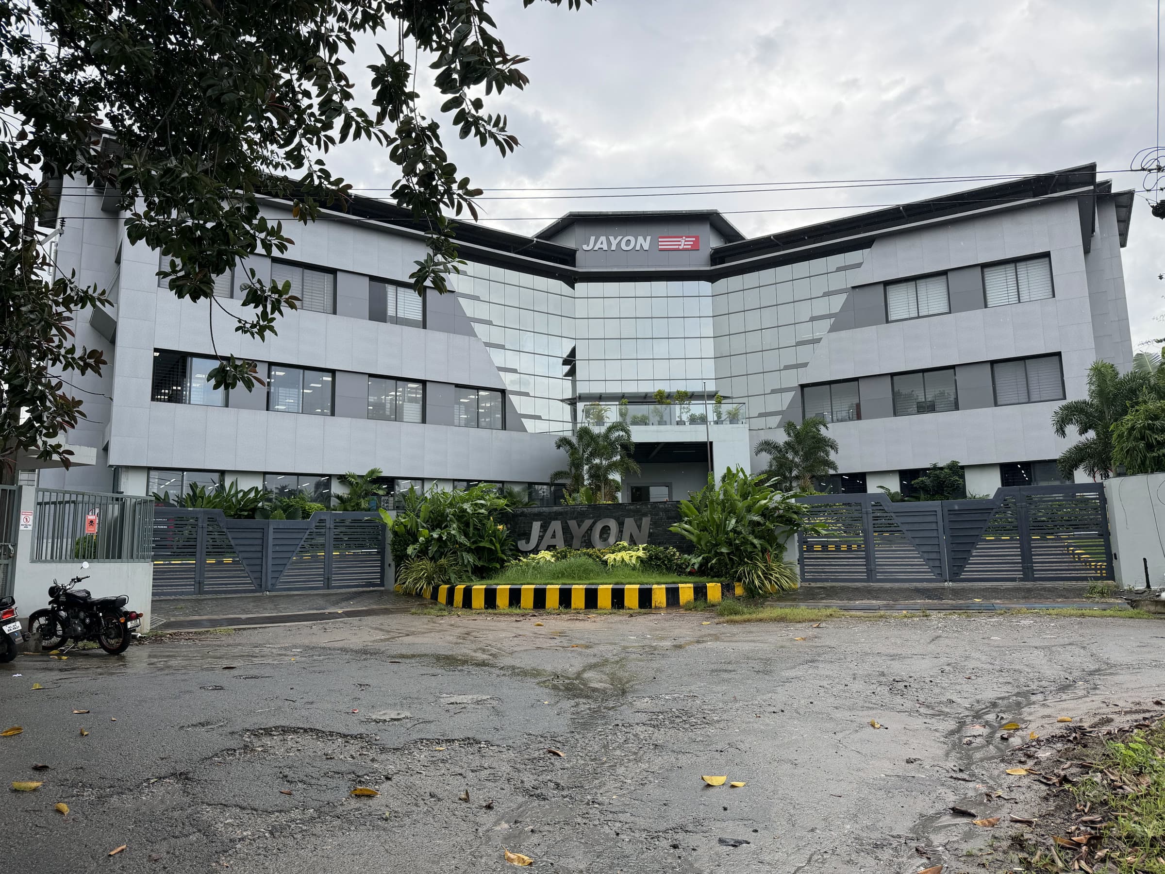 JMD — the building seen from the road through its gates
