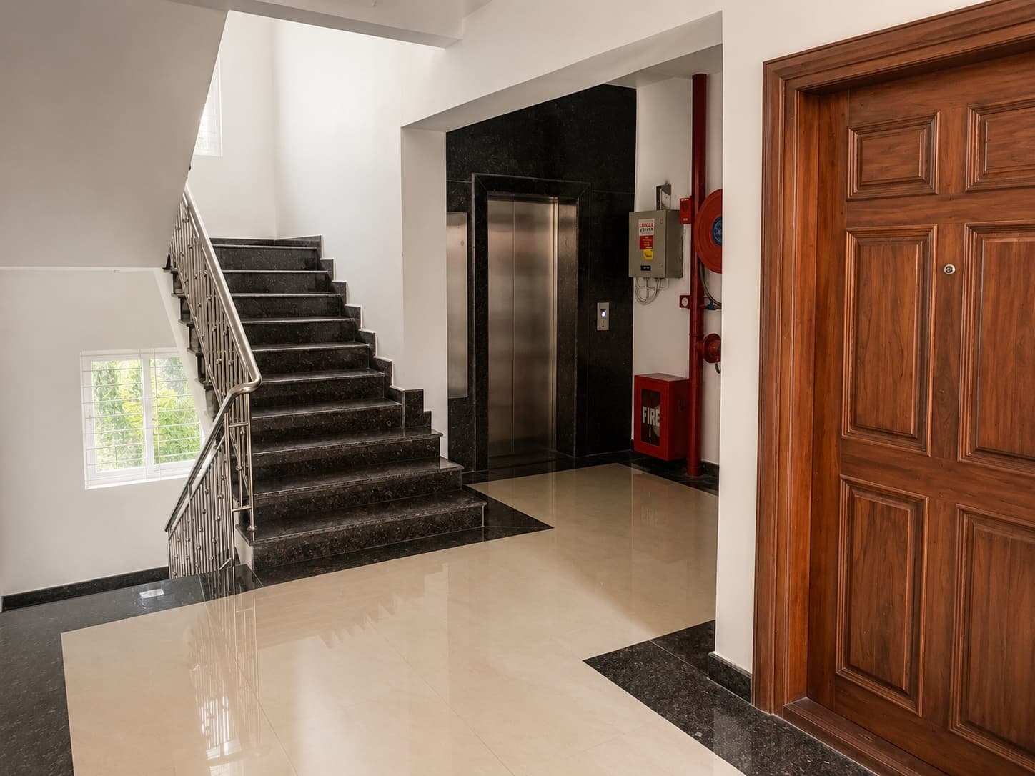 Village Nest — granite stair and lift lobby with polished marble floor